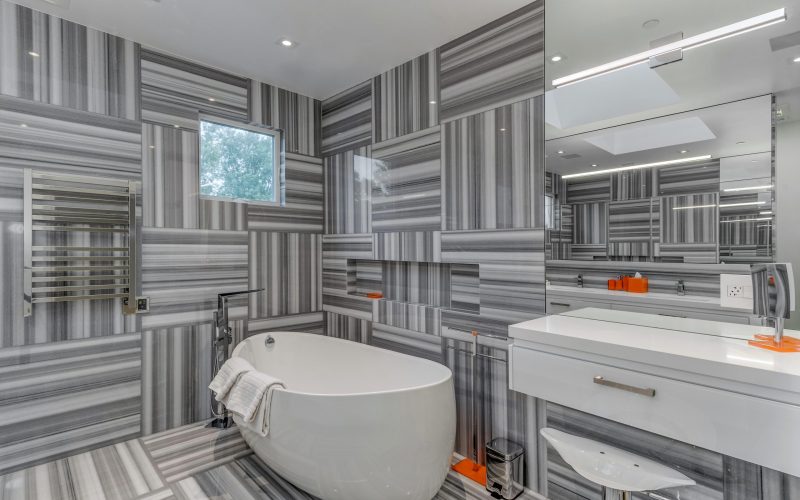 Bathroom with bathtub, mirror, and matching wall and floor in Glenview Princeton Club remodel